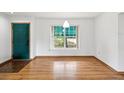 Bright entryway with hardwood floors and a view to the landscaped front yard at 6197 Belkton Ave, Spring Hill, FL 34608
