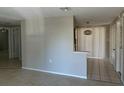 Neutral living room featuring tile flooring and an open floorplan at 6406 Stone Rd, Port Richey, FL 34668