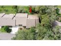 Aerial view of the home, showing its roof and surrounding mature trees at 6620 Brambleleaf Dr, Spring Hill, FL 34606