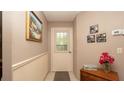 Inviting entryway with a white front door and charming decor at 6620 Brambleleaf Dr, Spring Hill, FL 34606