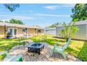 Serene backyard featuring a fire pit area, perfect for outdoor entertaining and relaxation at 6656 Pinecrest N Ln, Pinellas Park, FL 33781