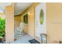 Inviting front porch with a rocking chair, creating a cozy and welcoming entryway to the home at 6656 Pinecrest N Ln, Pinellas Park, FL 33781