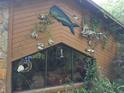 Close-up of the home's exterior showcasing artistic fish adornments and unique architectural details at 7323 Ray Browning Rd, Brooksville, FL 34601