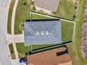 Aerial view of a home with a gray roof, a fenced yard, and a well-maintained lawn at 7523 Tangle Brook Blvd, Gibsonton, FL 33534