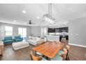 Bright and open living space with modern furnishings, flowing seamlessly into the kitchen and dining area at 7523 Tangle Brook Blvd, Gibsonton, FL 33534
