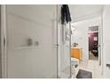Bathroom featuring a glass-enclosed shower, light wood vanity and tiled floors at 8634 Roble Way, Port Richey, FL 34668