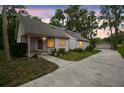 Charming single-story home with a long driveway, detached garage, and mature trees creating a peaceful setting at 8755 Marigold Dr, New Port Richey, FL 34654