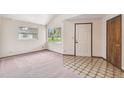 Bright foyer area features neutral walls, decorative floor tiles, and large windows at 8755 Marigold Dr, New Port Richey, FL 34654
