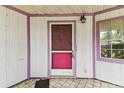 Close-up of the home's charming front door and covered porch area at 8755 Marigold Dr, New Port Richey, FL 34654