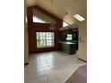 Open living space features tile flooring, high ceilings, and unique chandelier at 8755 Marigold Dr, New Port Richey, FL 34654