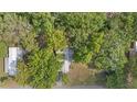 Aerial view of a property surrounded by lush, mature trees, offering privacy at 9401 Bourbon St, New Port Richey, FL 34654