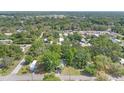 Community aerial view with tree coverage and neighborhood streets on a sunny day at 9401 Bourbon St, New Port Richey, FL 34654