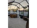 Enclosed patio with a hot tub and string lights at sunset at 9967 Patrician Dr, New Port Richey, FL 34655