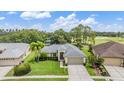 Stunning aerial view of a single-story home with lush landscaping and a golf course nearby at 1033 Ashbourne Cir, Trinity, FL 34655