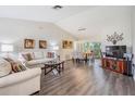Bright living room featuring hardwood floors, neutral walls, and modern furniture at 1033 Ashbourne Cir, Trinity, FL 34655
