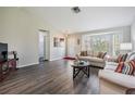 Comfortable living room with bay windows, hardwood floors, and a cozy seating arrangement at 1033 Ashbourne Cir, Trinity, FL 34655