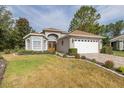 Charming single-story home featuring a well-manicured lawn and a two-car garage at 11404 Inman Ct, Spring Hill, FL 34609