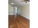 Bright living room with hardwood floors, neutral walls, and an open floor plan at 11520 Lounds Ct, New Port Richey, FL 34654