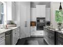 A sleek kitchen featuring stainless steel appliances, stone countertops, an island, and custom cabinetry at 12085 Stringer Rd, Brooksville, FL 34601