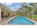 Screened-in pool with clear blue water, perfect for relaxation and enjoying the outdoors at 12805 Coronado Dr, Spring Hill, FL 34609