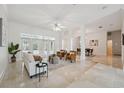 Bright living room featuring an open layout, marble flooring, and seamless flow to the dining area at 1471 N Jasmine Ave, Tarpon Springs, FL 34689