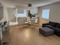 Open concept living space with modern furniture, wood floors, and access to the kitchen at 2270 Alden Ln # A, Palm Harbor, FL 34683