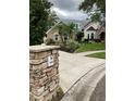 View of house exterior with stone mailbox in the yard at 2880 Chelsea N Pl, Clearwater, FL 33759