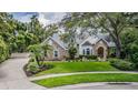 Beautiful two-story home with lush front lawn and a circular driveway at 2880 Chelsea N Pl, Clearwater, FL 33759
