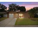 Charming single-story home with a well-maintained lawn, driveway, and attached one-car garage at 2887 Cathy Ln, Clearwater, FL 33760