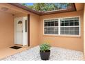 Welcoming entryway with a decorative glass door, accent plants and a welcome mat at 2887 Cathy Ln, Clearwater, FL 33760