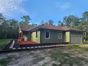 A well-maintained home featuring a new roof, an attached garage, and lush, mulch landscaping at 34335 Berryhill Dr, Webster, FL 33597