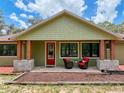 Inviting front porch with comfortable seating area and stylish design elements that exude curb appeal at 34335 Berryhill Dr, Webster, FL 33597