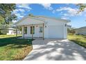 Charming single-story home featuring white siding, a covered porch, and an attached garage at 3554 Arrowhead Ave, Spring Hill, FL 34606