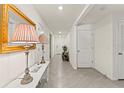 Bright hallway featuring neutral tiles, multiple rooms, and elegant decor that creates a welcoming atmosphere at 3900 Autumn Amber Dr, Spring Hill, FL 34609