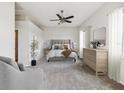 Neutral bedroom showcases a plush bed, soft carpet and an ensuite bathroom at 4266 High Ridge Ave, Spring Hill, FL 34609