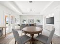 Bright living room features neutral tones, recessed lighting, and an adjacent dining area at 4266 High Ridge Ave, Spring Hill, FL 34609