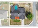 Aerial view of the house with a screened pool, and a large backyard with a fire pit at 4289 Castle Ave, Spring Hill, FL 34609