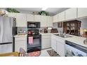 A compact kitchen offering essential appliances and ample cabinet storage for cooking and meal preparation at 4557 Glen Holw, New Port Richey, FL 34653