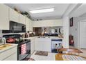 A compact kitchen offering essential appliances and ample cabinet storage for cooking and meal preparation at 4557 Glen Holw, New Port Richey, FL 34653