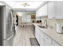 Open kitchen with stainless steel appliances, white cabinets, and a view into the breakfast nook and Gathering room at 4841 Wakefield Ct # 4841, New Port Richey, FL 34655