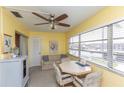 Bright sunroom featuring ample natural light, seating and a ceiling fan at 5123 Topaz Ln # 206, New Port Richey, FL 34652