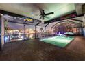 Inviting screened-in pool area with unique decor and stylish lighting for evening swims at 6601 Nautical Isle, Hudson, FL 34667