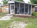 Inviting cottage home featuring stone finishes and a cozy, screened-in porch area perfect for outdoor enjoyment at 7100 Ashwood Dr, Port Richey, FL 34668