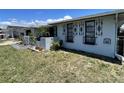Exterior view of a well-kept home with decorative window bars and a neat, green lawn at 7534 Briarwood Dr, Port Richey, FL 34668