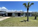 Charming single-story home featuring a well-manicured front yard and inviting curb appeal at 7534 Briarwood Dr, Port Richey, FL 34668