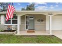 Inviting front entrance with decorative welcome decor and a modern gray front door at 7545 Banner St, New Port Richey, FL 34653