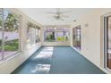 Enclosed sunroom with lots of windows, ceiling fan, and sliding glass door to the outside at 8248 Sugarbush Dr, Spring Hill, FL 34606