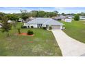 Charming single-story home with a well-manicured lawn, long driveway and inviting curb appeal at 8283 Shoup St, Spring Hill, FL 34606