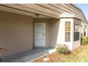Close-up of a front entrance with a white front door and a bay window at 9529 Bunker Hill Ct # 9529, New Port Richey, FL 34655
