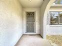 The entryway features a secure metal gate and a textured exterior wall at 10139 Carrin Rd, Spring Hill, FL 34608